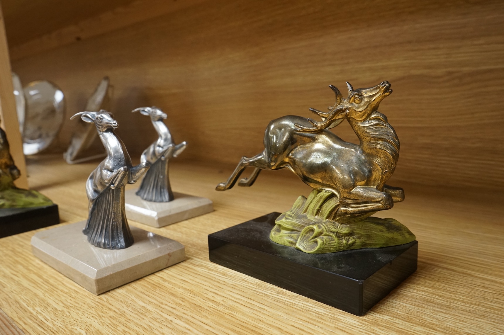 Two pairs of Art Deco bookends in the form of leaping animals, largest 14cm wide